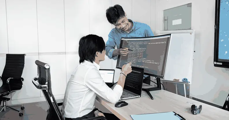 Career switcher exploring an artificial intelligence course for beginners with a mentor at a desk