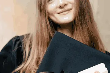 Smiling graduate holding a certificate, representing eligibility for the artificial intelligence and machine learning course